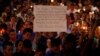 A man holds up a sign saying Arab Muslims condemn the attack as he takes part in a candlelight memorial service after a mass shooting at the Pulse nightclub in Orlando, Florida, June 13, 2016.