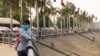 FILE: Girls wear mask in the park in front of the Royal Palace in Phnom Penh, Cambodia, February 1th, 2020. (Malis Tum/VOA Khmer)