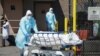 Bodies are moved to a refrigeration truck serving as a temporary morgue at Wyckoff Hospital in the Borough of Brooklyn on April 6, 2020 in New York.