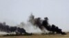 This picture released on Wednesday, May 20, 2015 on the website of Islamic State militants, shows black columns of smoke rising through the air during a battle between Islamic State militants and the Syrian government forces on a road between Homs and Palmyra.