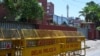 FILE - Police barricades are seen in front of the gate of the Twitter India's office at Crescent building in New Delhi on May 25, 2021, as police served a notice at Twitter's offices over flagged governments tweets as "manipulated media" a day before.