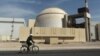 FILE: A bicyclist passes the nuclear power plant just outside Bushehr, Iran.