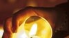 Woman lights candle at 'night of lights' ecumenical prayer, Erfurt, Germany, Nov. 23, 2011 (file photo).