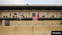 FILE - A U.S. flag is seen on a housing unit fro U.S. forces inside of Bagram Air Field in the Parwan province of Afghanistan, Jan. 2, 2015. 