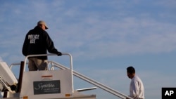 FILE - A to-be-deported illegal immigrant from Latin America boards a flight chartered by U.S. Immigration and Customs Enforcement, in Houston, Texas, Nov. 16, 2018. 
