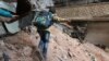 A child navigates rubble and barbed wire in Aleppo, Syria, Feb. 11, 2016.
