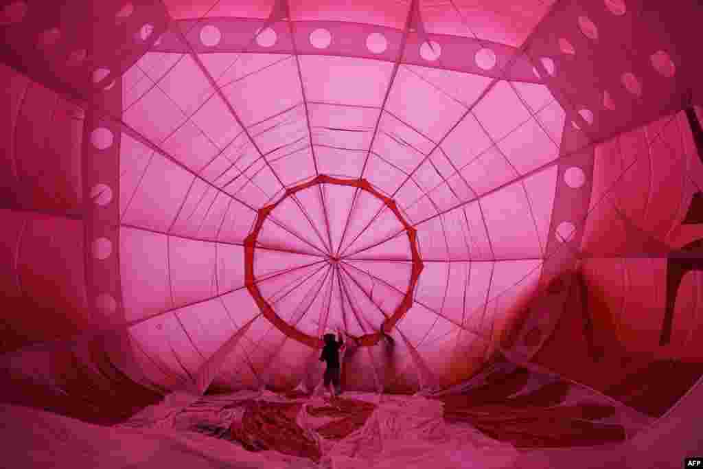 Balloonists prepare to inflate their hot air balloons on the second day of the Bristol International Balloon Fiesta in Bristol, southwest England, on August 12, 2016.