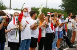People form a human chain to show support to protesters in Belarus in Medininkai, Lithuania, Aug. 23, 2020.