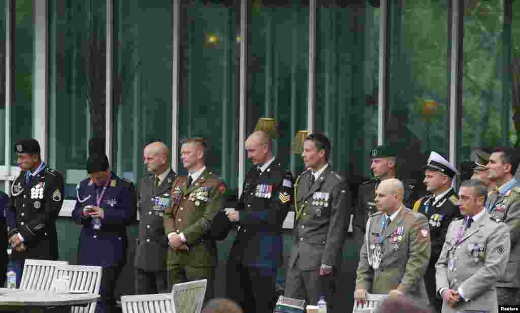Military personnel wait outside as leaders from the U.S., France, Italy, Germany, the United Kingdom and Ukraine participate in a meeting on the situation in Ukraine at the NATO Summit at the Celtic Manor Resort in Newport, Wales, Sept. 4, 2014.