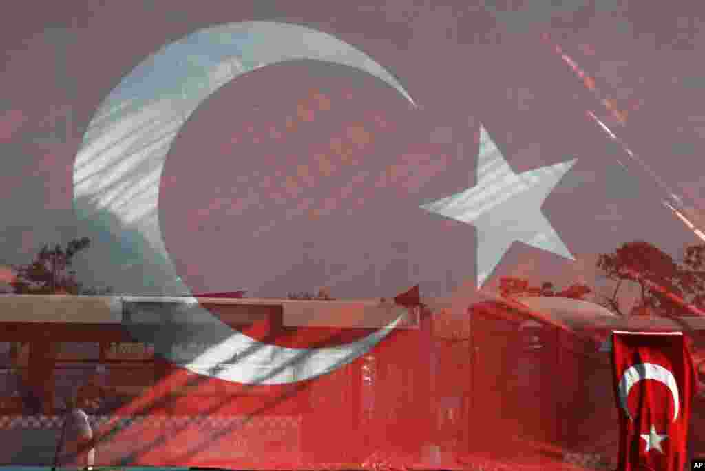 A man walks behind a giant Turkish flag at Besiktas area in Istanbul. The government crackdown in the coup's aftermath has strained Turkey's ties with key allies including the United States.