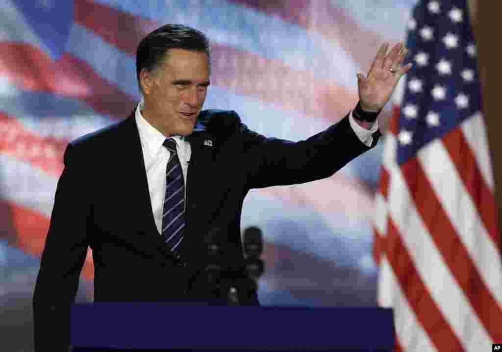 Republican presidential candidate Mitt Romney waves to supporters before conceding at his election night rally, November 7, 2012, in Boston, Massachusetts.