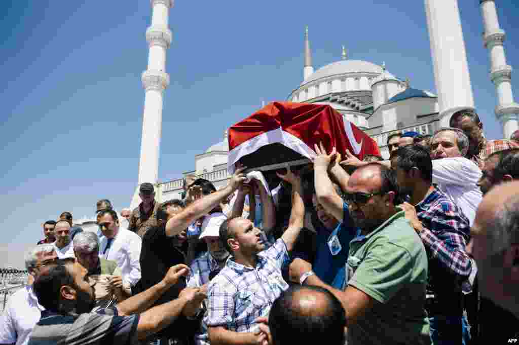People carry the coffin of victim of the coup attempt Sehidmiz Murat Inci during his funeral ceremony at the Kocatepe Mosque in Ankara, Turkey.