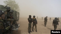 FILE - Cameroonian soldiers from the Rapid Intervention Brigade stand guard in Kolofata, March 16, 2016. Cameroon military arrested several Boko Haram fighters and their 25 female accomplices who were attempting to supply food and weapons through Cameroon to the fighters in Nigeria.