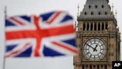 FILE - The British Union flag flutters in front of "Big Ben" Tower at the Houses of Parliament, in central London, March 29, 2017.