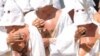 Christian penitents known locally as "Battenti" beas themselves during a procession in honor of the Virgin Mary in Guardia Sanframondi, on August 22, 2010.