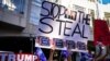President Donald Trump supporters gather with signs claiming a stolen election outside the Philadelphia Convention Center as they await general election tabulation results, in Philadelphia, Nov. 6, 2020.