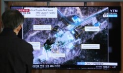 FILE - In this March 6, 2019 file photo, a man watches a TV screen showing an image of the Sohae Satellite Launching Station in Tongchang-ri, North Korea, during a news program at the Seoul Railway Station in Seoul, South Korea.