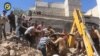 FILE - Civil defense workers and Syrian citizens inspect damage to buildings after airstrikes hit a market area in Idlib, Syria, June. 12, 2016.