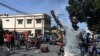 Demonstrators march on the street near parliament as they protest against ruling government in Port-au-Prince, Sept. 23, 2019. 