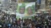 Supporters of the opposition Sierra Leone People's Party (SLPP) march through central Freetown with a placard of presidential candidate Julius Maada Bio and his running mate, Dr. Kadi Sesay, in Freetown, Sierra Leone, October 19, 2012. 
