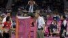 Head badminton referee Torsten Berg, right, talks to Indonesia's Greysia Polii, left, after he issued a black card to Polii and her partner Meiliana Jauhari as well as Ha Jung-eun and Kim Min-jung, of South Korea, unseen, during their women's doubles badm