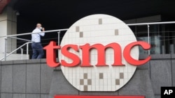 FILE - A person walks into the Taiwan Semiconductor Manufacturing Co., headquarters in Hsinchu, Taiwan on Oct. 20, 2021. The company said on May 16, 2024, there was no damage to facilities after an explosion at an Arizona factory construction site.