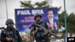 FILE - Members of the Cameroonian gendarmerie patrol in the Omar Bongo Square of Cameroon's majority anglophone South West province capital, Buea, during a political rally of the ruling CPDM party, Oct. 3, 2018.