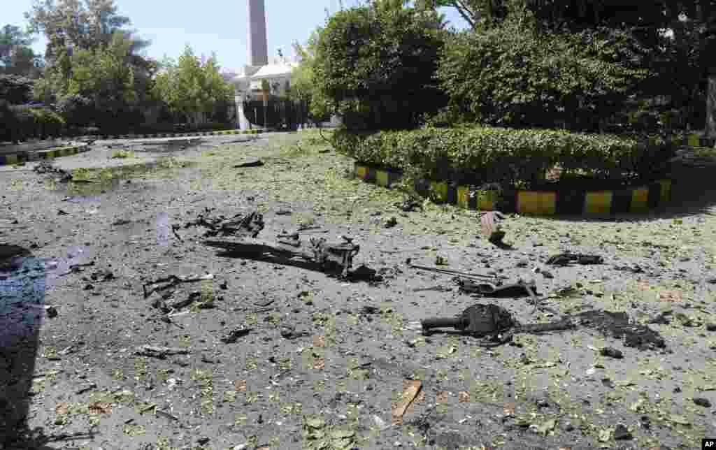 The Syrian official news agency SANA photo shows the remains of a vehicle and other debris where they landed after a car exploded at Syria's army command headquarters in Damascus, Syria, Sept. 26, 2012.