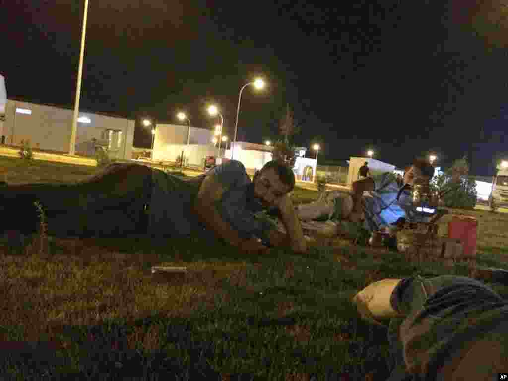 In this June 9, 2014 photo, Turkish truck drivers Ceyhun Ismaloglu (left) and Servet Karakan relax on the grounds of the Qayara Power Station in Iraq. The drivers were kidnapped by the Islamic State the following morning. The episode paints a picture of a militant group (IS) unusually careful not to anger Turkey’s government - and offers insight into the mysterious release of 49 Turkish hostages in late September, 2014.
