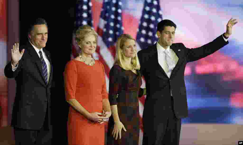 Republican presidential candidate Mitt Romney and his wife Ann stand on the stage with Republican vice presidential candidate Paul Ryan,and his wife Janna during his election night rally, November 7, 2012, in Boston, Massachusetts.