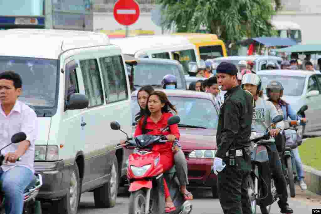 អាជ្ញាធរកំពុងជួយសម្រួលចរាចរណ៍ ដល់ប្រជាពលរដ្ឋកម្ពុជាដែលធ្វើដំណើរទៅកាន់ស្រុកកំណើត ដើម្បីប្រារព្ធពិធីបុណ្យភ្ជុំបិណ្ឌ ក្នុងរាជធានីភ្នំពេញ កាលពីថ្ងៃទី៣០ ខែកញ្ញា ឆ្នាំ២០១៦។ (ហ៊ាន សុជាតា/ VOA) 