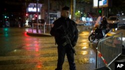A French police officer stands guard near the Bataclan concert hall in Paris, Saturday, Nov. 12, 2016. The hall was among venues targeted a year ago by terrorists in coordinated attacks that left 130 people dead. 