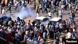 
Para demonstran melarikan diri untuk menghindari tembakan gas air mata saat menggelar unjuk rasa anti-pemerintah di Khartoum, Sudan, 25 Desember 2018.
