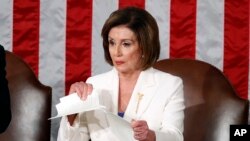 House Speaker Nancy Pelosi of Calif., tears her copy of President Donald Trump's State of the Union address after he delivered it to a joint session of Congress in Washington, Feb. 4, 2020.