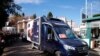 A refrigerated truck is escorted by Italian Police as it arrives at the Spallanzani hospital to deliver the first doses of vaccine for the COVID-19 in Rome, Dec. 26, 2020.