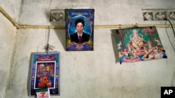 A portrait of Parasuraman Thulasiyamma's missing son is displayed with pictures of Hindu deities inside their home in Mullaitivu, Sri Lanka, May 7, 2024. Sri Lanka's civil war ended 15 years ago, but many people are still searching for missing family members.