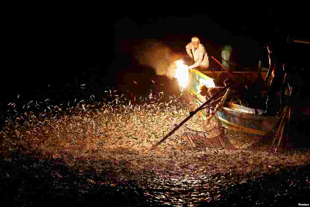 Fishermen use a fire to attract fish on a traditional “sulfuric fire fishing" boat in New Taipei City, Taiwan.