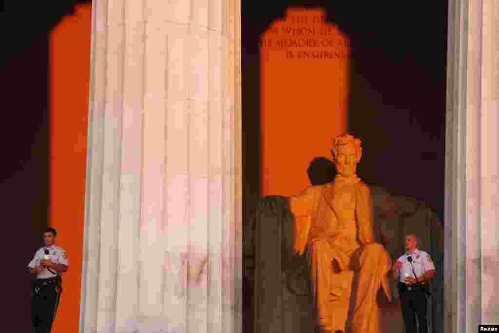 U.S. Park Police watch over the Lincoln Memorial during sunrise early in the morning before the start of the ceremony honoring the 50th anniversary of the 1963 March on Washington, Aug. 24, 2013.