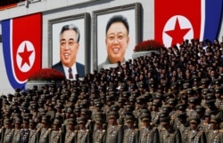 FILE - Senior military officials watch a parade as portraits of late North Korean leaders Kim Il Sung and Kim Jong Il are seen at the main Kim Il Sung square in Pyongyang, Sept. 9, 2018.