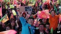 FILE - Supporters of Taiwan President Tsai Ing-wen's candidacy for re-election in 2020 cheer for Tsai's victory, in Taipei, Taiwan, Jan. 11, 2020.