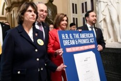 House Speaker Nancy Pelosi. second from right, joined by, from left, Rep. Lucille Roybal-Allard, Senate Minority Leader Sen. Chuck Schumer, and Rep. Joaquin Castro, carry a sign as they walk on Capitol Hill, Nov. 12, 2019.