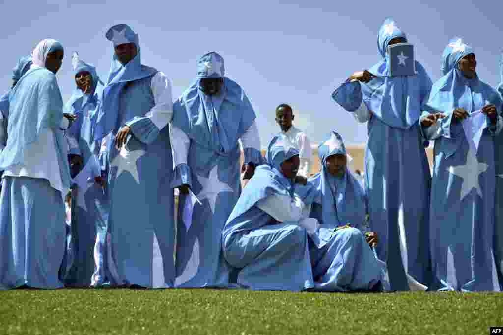 Women adorned in Somali flags celebrate the country's Independence Day at Konis stadium in Mogadishu. Today's celebrations mark 53 years since the Southern regions of Somalia gained independence from Italy and joined with the Northern region of Somaliland to create Somalia.