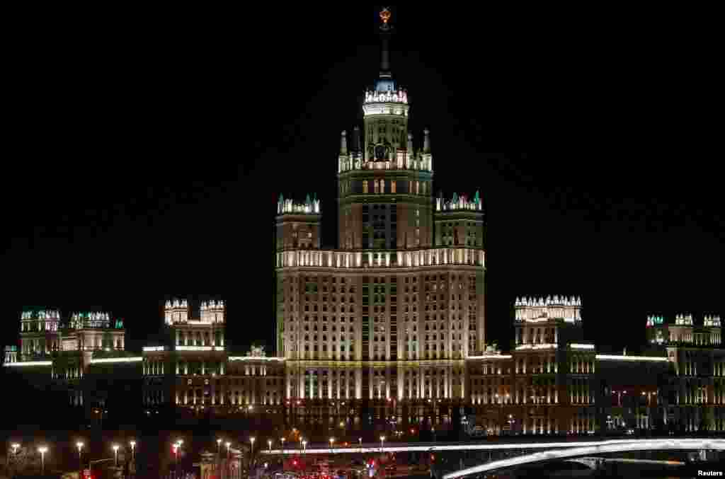 Stalin's era skyscraper is seen before the lights are switched off for Earth Hour in Moscow, March 30, 2019.