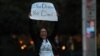 FILE - A demonstrator, part of a group blocking traffic, demands action by the federal government on the Deferred Action for Childhood Arrivals program in San Diego, Calif., Dec. 4, 2017. 