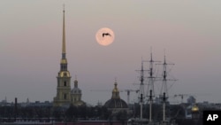 FILE - A bird is silhouetted against full moon in St. Petersburg, Russia, March 29, 2021. Russia on Saturday ordered the expulsion of Ukraine's consul in St. Peterburg for allegedly trying to obtain classified information.