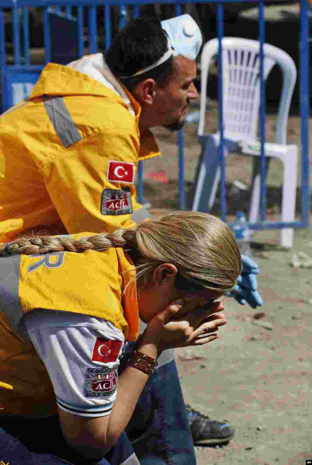 Members of the rescue team sit outside the coal mine in Soma, May 15, 2014.