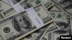 FILE - U.S. one-hundred dollar bills are shown in this Aug. 2, 2013, photo illustration.